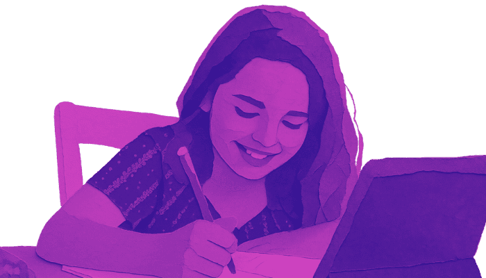 Student smiling while writing at her desk